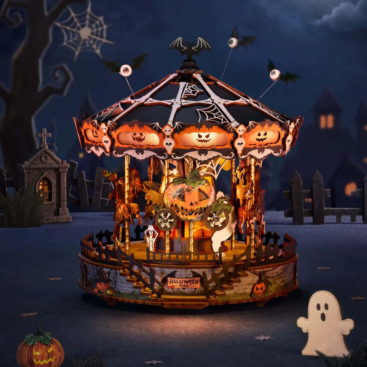Illuminated Phantom Waltz Halloween carousel with glowing pumpkin faces and bats in a nighttime graveyard scene.