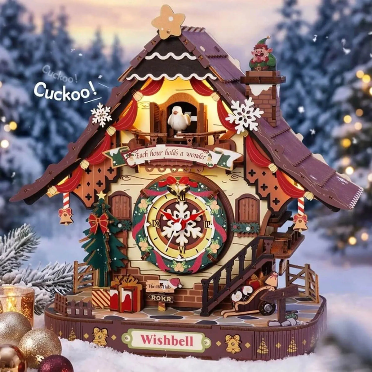 Assembled ROKR LCB01 Christmas cuckoo clock in a festive scene with snowy trees and ornaments