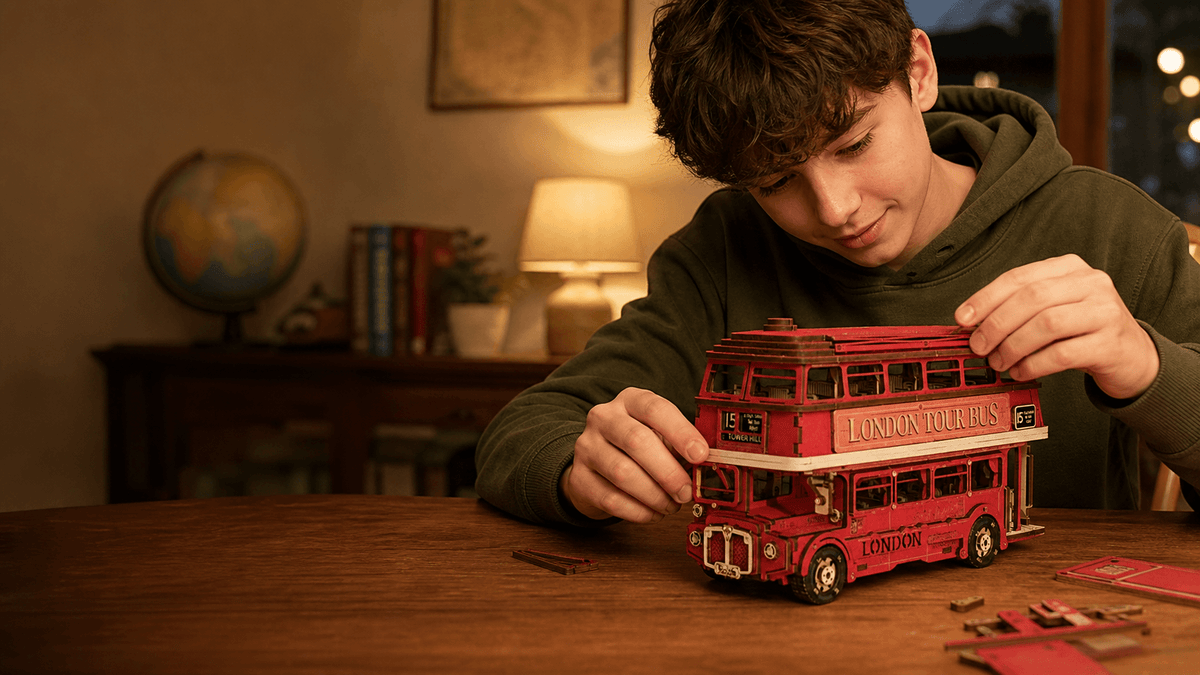 Young teenager assembling the red London Tour Bus 3D wooden puzzle at a cozy table.