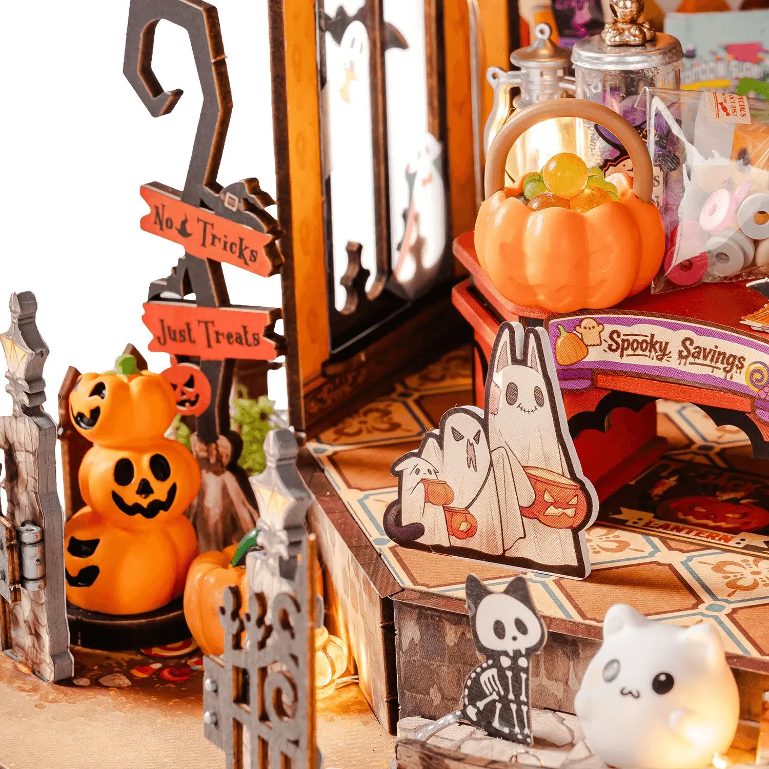 Haunted Candy House entrance with pumpkins, ghosts and opening gate