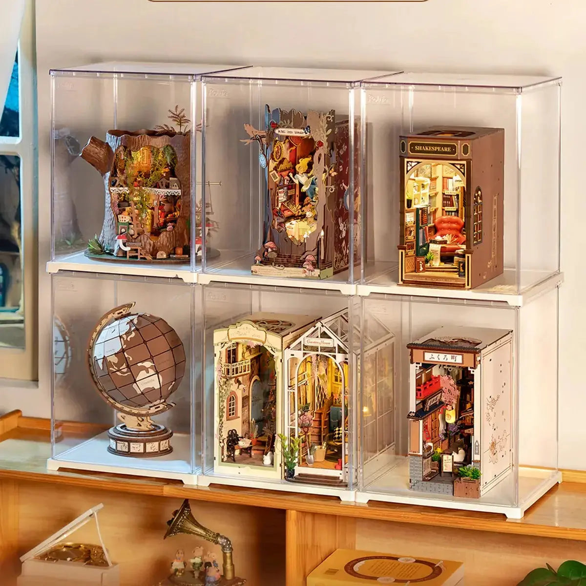 Large clear display cases holding book nooks and miniature houses
