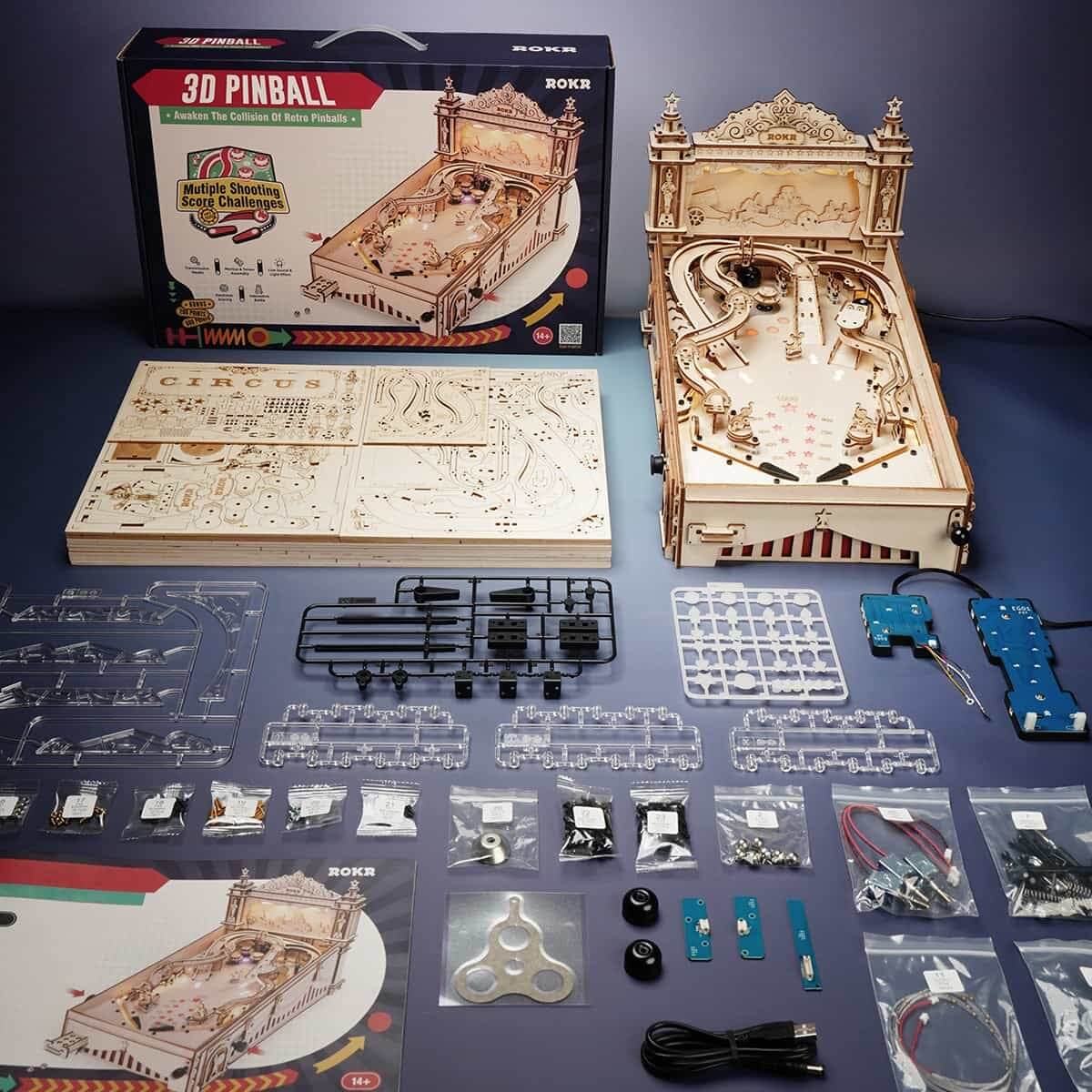 ROKR EG01 wooden pinball machine kit with wooden pieces, electronic components, instructions and assembled model