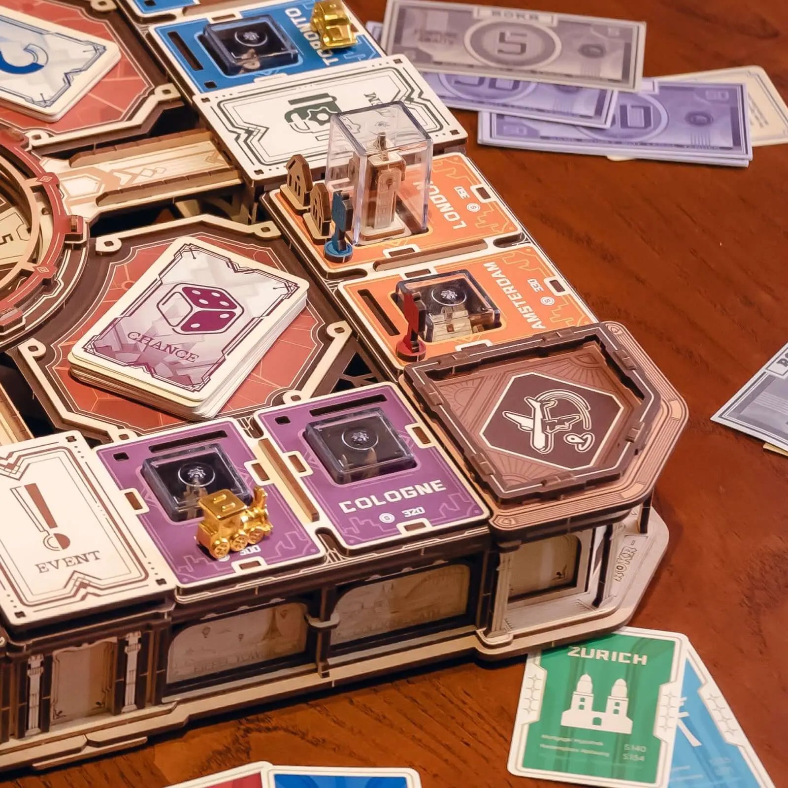 Close-up of Fortune Quest landmarks, property spaces, cards, banknotes and player tokens