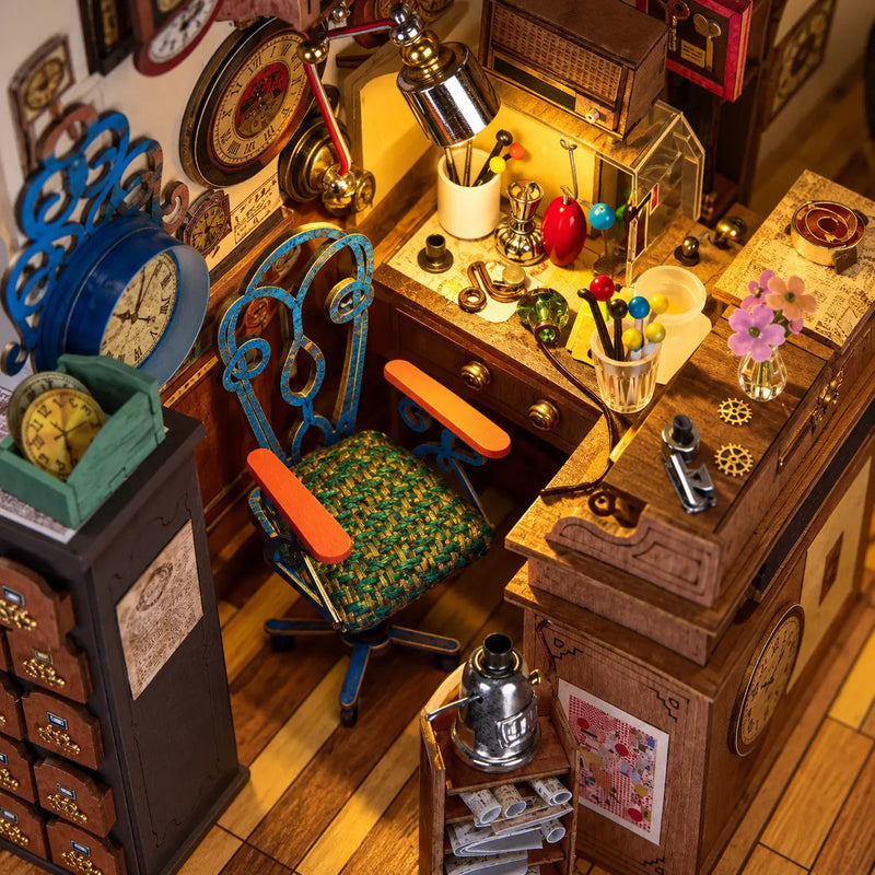 High-angle view of the L-shaped workbench, blue chair and tiny tools in the Rolife Clockwise Clocks DH104 miniature house.