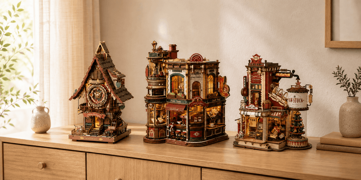 Three detailed wooden model kits displayed on a warm wooden cabinet in a cozy home interior