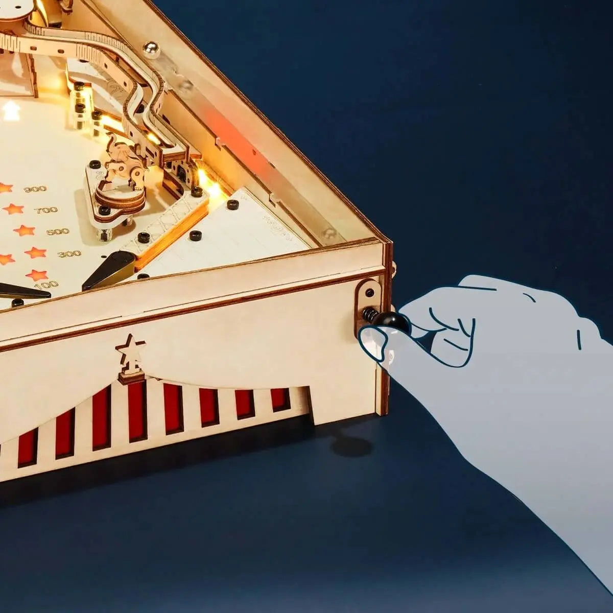 Close-up of the spring-loaded ball launcher on the wooden pinball machine ready to launch the steel ball