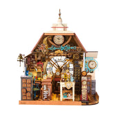 Front view of Rolife Clockwise Clocks DH104 miniature house with a clock tower, red roof and detailed clockmaker’s workshop.
