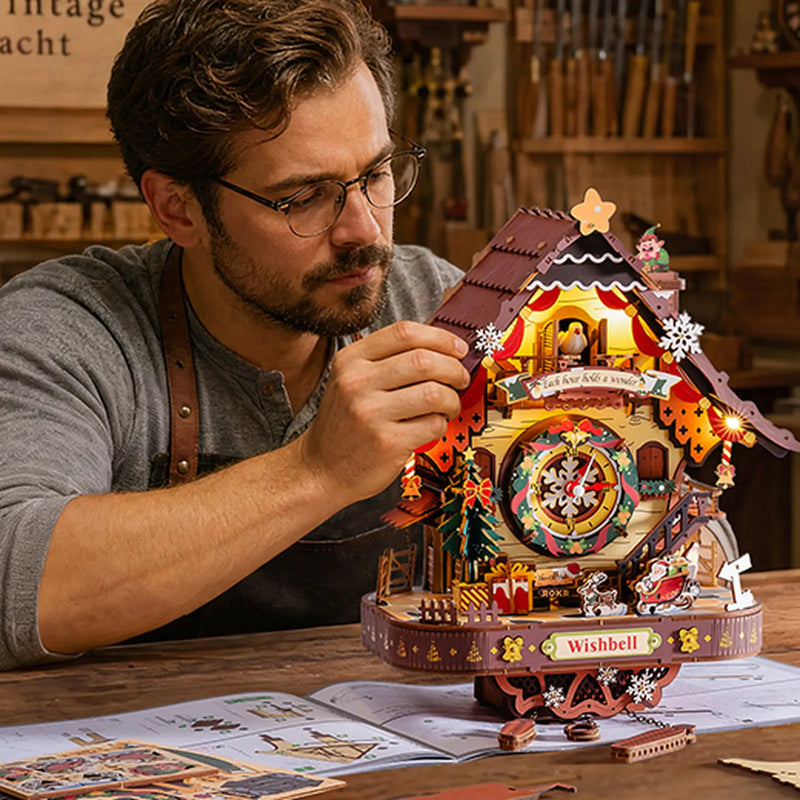 Man assembling the ROKR LCB01 Christmas cuckoo clock at a wooden workbench with illustrated instructions.