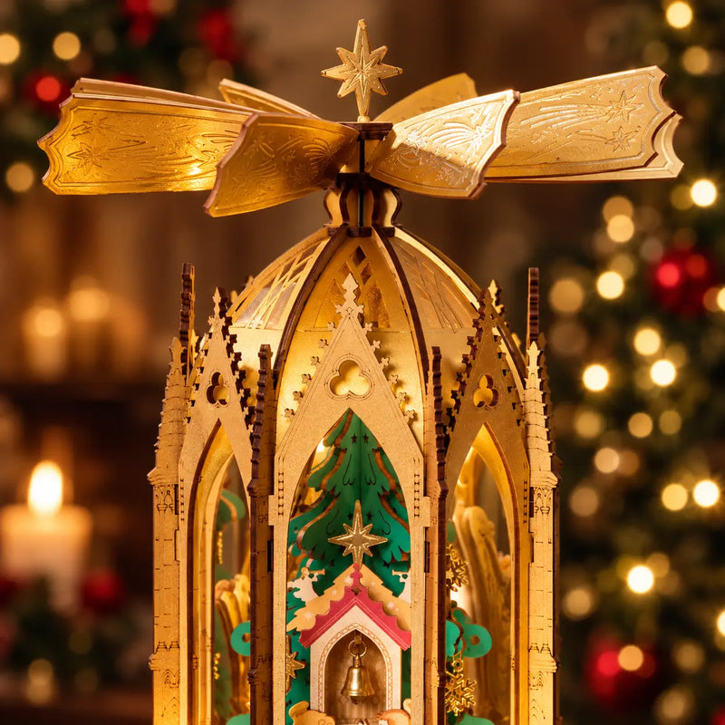 Close-up of the golden rotor, central star and pointed wooden arches on the ROKR AMB01 Christmas pyramid.