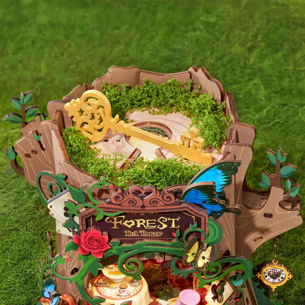 Top view of the Forest Tea Party AMT03 wooden music box, showing a decorative golden key and moss-covered treetop.