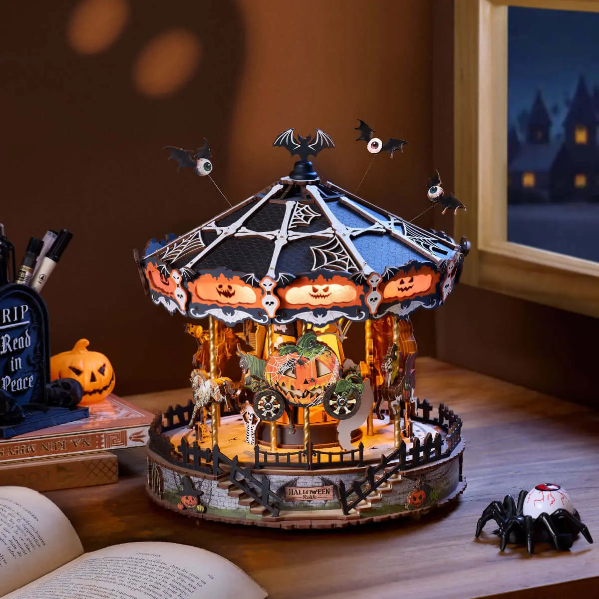 Phantom Waltz Halloween carousel displayed alongside several other miniature kits on a tabletop.