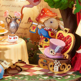 Close-up of the Forest Tea Party music box, showing a purple top hat on a rocking chair beside a rabbit illustration and tea table.