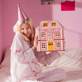Closed pink Fairy Rose Cottage held as a finished display model