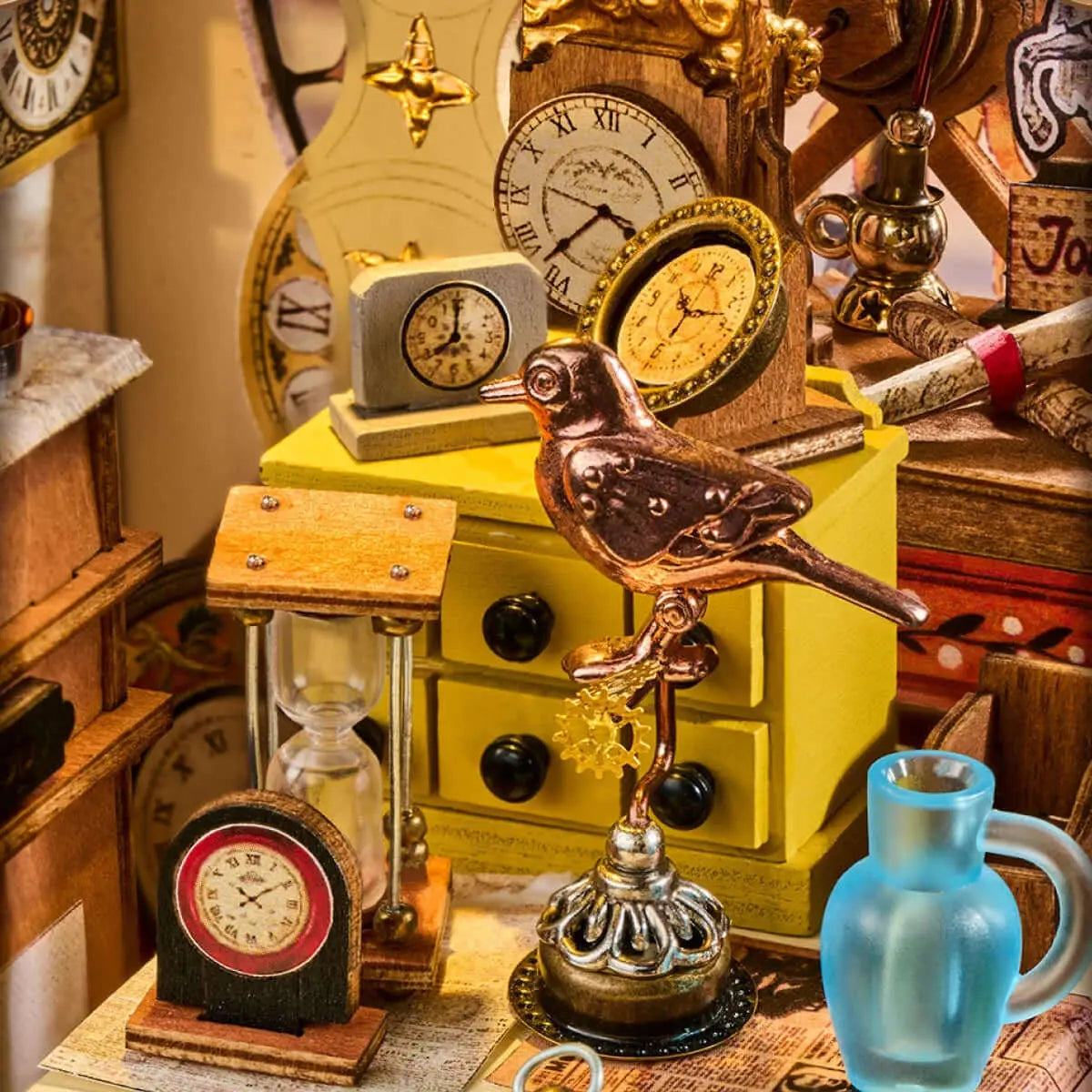 Rolife Clockwise Clocks DH104 workshop detail with a copper-coloured bird, an hourglass, miniature clocks and a blue jug.