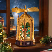 Illuminated ROKR AMB01 Christmas pyramid on a windowsill beside festive greenery and a small Christmas tree