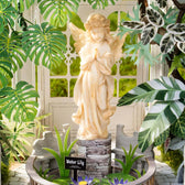 Angel statue, water lilies and garden benches inside the Rolife Oxygen Oasis greenhouse