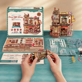 Builder assembling ROKR Dream Coffee Factory with wooden sheets and manual
