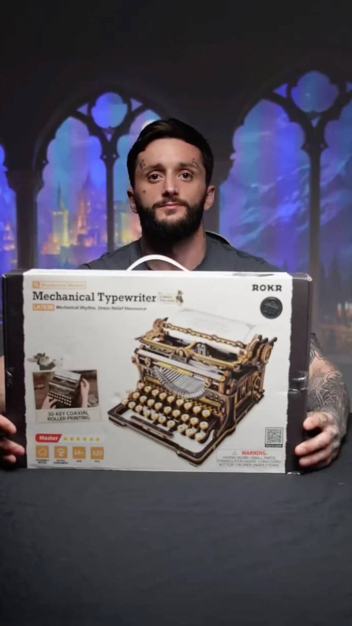 Builder holding the ROKR Mechanical Typewriter LK703B 3D wooden model kit