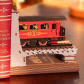 Red Century Train passenger carriage and railway bridge close-up beside a book
