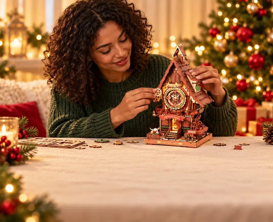 Woman working on a wooden mechanical clock model in a cozy Christmas setting.