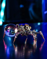 Jumping Spider mechanical model displayed under dramatic blue light