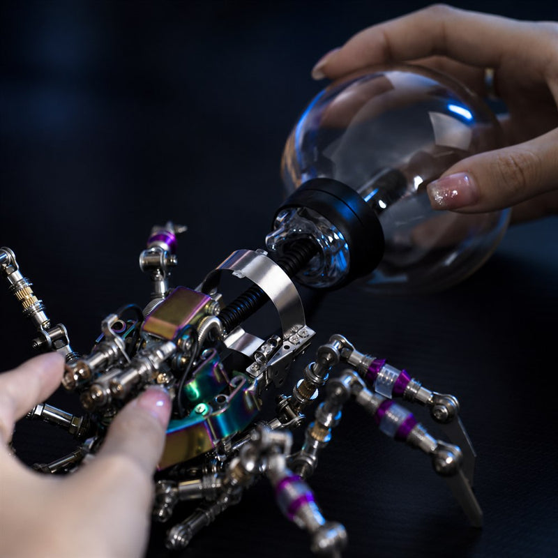 Hands fitting the plasma ball to the Mostarle Plasma Ball Spider metal model.