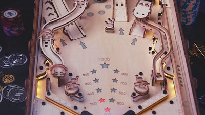 ROKR EG01 wooden pinball machine launching steel ball up ramp across illuminated playfield