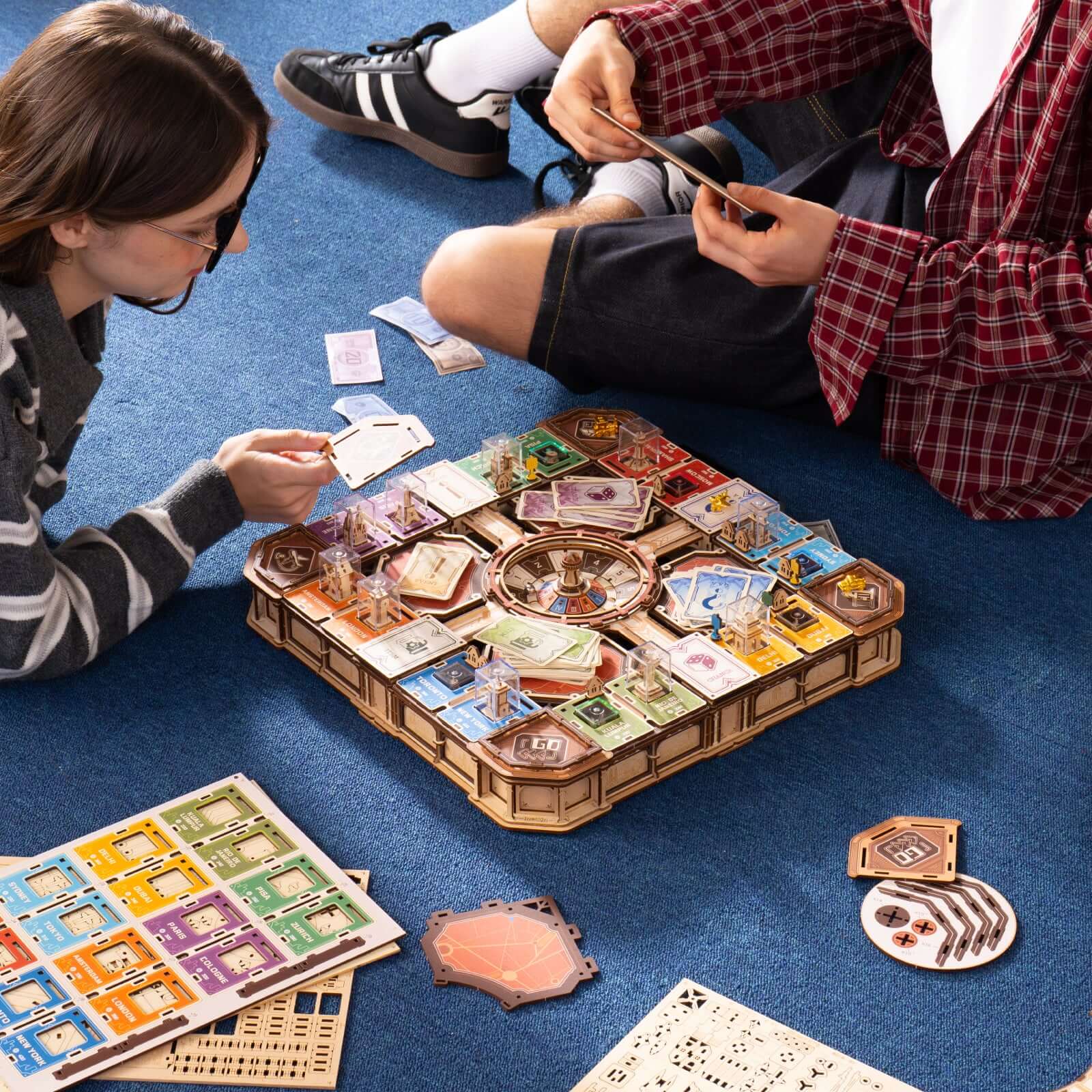 Players enjoying the assembled ROKR Fortune Quest puzzle beside wooden building pieces