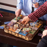 Players using the central marble spinner on the ROKR Fortune Quest wooden board game