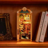 Romantic Venice book nook glowing between books on a dark bookshelf