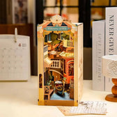 Completed Rolife Venice book nook displayed on a desk beside books and home décor