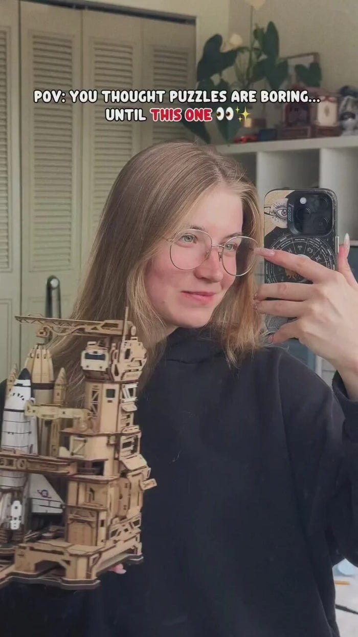 Woman displaying her completed ROKR Space Shuttle LKA02 wooden puzzle model